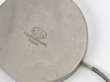 a silver plate with a rope on it on a white surface