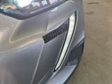 a close up of a car ' s hood with a clock on it