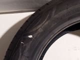 a close up of a tire on the side of a white wall