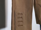 a close up of a suit with buttons on the lapel