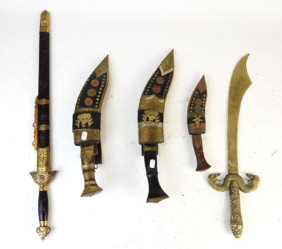four different types of knives are lined up on a white surface