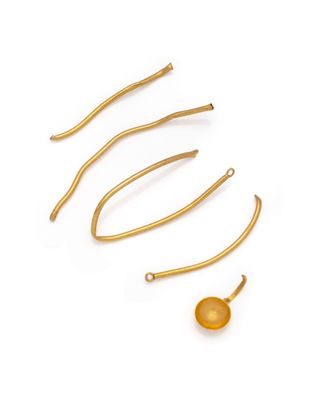 a set of five gold plated hair pins and a ball