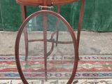 a small wooden table with a mirror on top of it