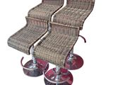 two brown wicker bar stools with chrome legs and a red base