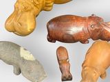 a lot of carved animals that are on the table