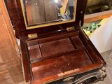 a small wooden box with a mirror on top of it