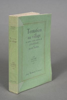 an old book sitting on top of a table on a gray surface