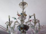 a glass chandelier hanging from the ceiling in a room