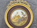 tableau représentant un paysage, dans un cadre doré, sur fond gris