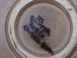 a close up of a brown vase with writing on it