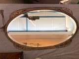 a mirror that is sitting on a table in a room