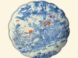 a blue and white plate with a painting on it