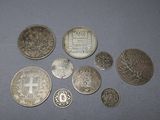 several silver coins sitting on a table next to each other