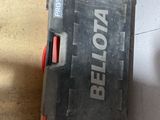 a tool box sitting on the floor next to a pair of scissors