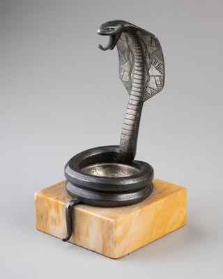 a sculpture of a cobra on a marble base