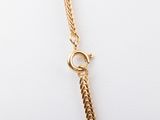 a close up of a gold chain with a clasp on it