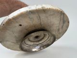 a person holding a silver object in their hand