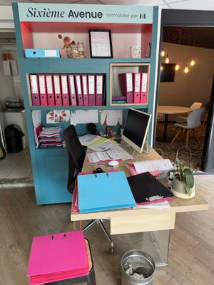 a desk that has a lot of papers on it