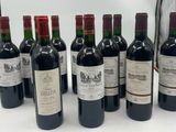six bottles of wine are lined up in a row on a table