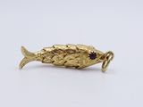 an image of a gold fish broochle with a red stone in its mouth