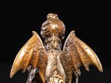an antique bronze figurine of a boy with wings on a base