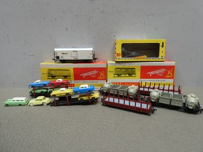 a lot of toy trains and trucks sitting on a table
