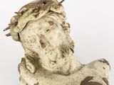 an old statue of a man with a crown of thorns on his head