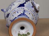 a blue and white vase with a bird on it