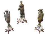 four different sized vases sitting on top of a table next to each other