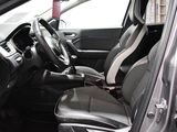the interior of a car with black and white seats and a steering wheel