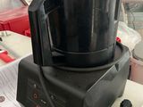 a black blender sitting on a counter in a kitchen