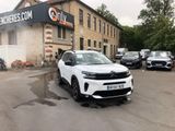 a white car that is parked in front of a building