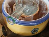 a yellow bowl with a spoon in it on a table