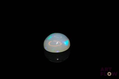 a white oplite in the dark with a black background