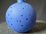 a blue ornament with stars on it sitting on a table
