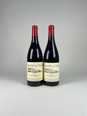 two bottles of red wine sitting next to each other on a table