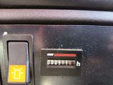 a close up of a car ' s dashboard with a yellow button