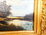 painting of a landscape with a river and trees in a gold frame
