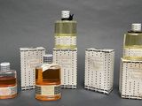 several bottles and containers of different types of perfumes on a table