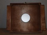 a picture of a wooden picture frame with a white button