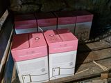 two boxes of soap sitting on a shelf next to a box of soap