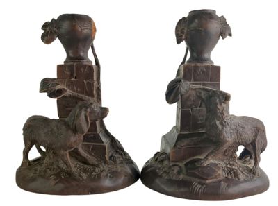 two statues of a man and a woman with animals on them