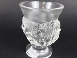 an image of a clear glass cup with a flower decoration