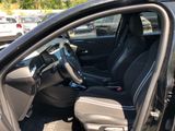 the interior of a car with the door open and the driver ' s seat down
