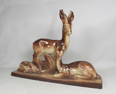 a figurine of a deer and a baby deer on a wooden base