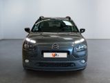 the front of a grey citrole car parked in a garage
