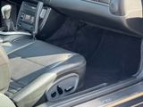 the interior of a car with the door open showing the steering wheel and dashboard