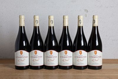 six bottles of red wine lined up on a wooden table
