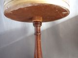 a wooden table with a glass top and a wooden base