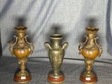 three gold vases sitting on top of a table next to each other
